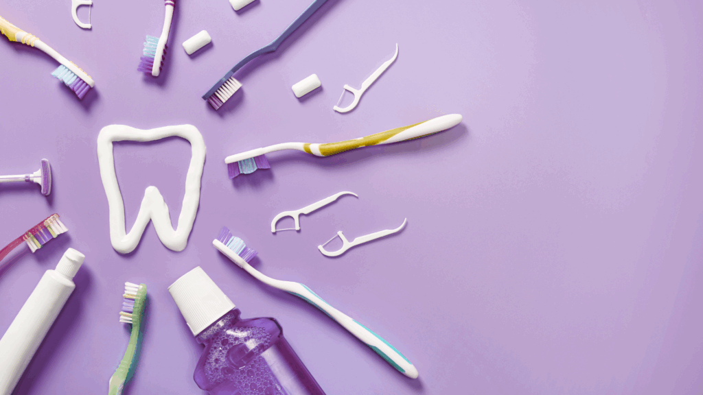Close-up of dental care products and tools, including toothbrushes, floss, mouth rinse, and hygiene instruments.